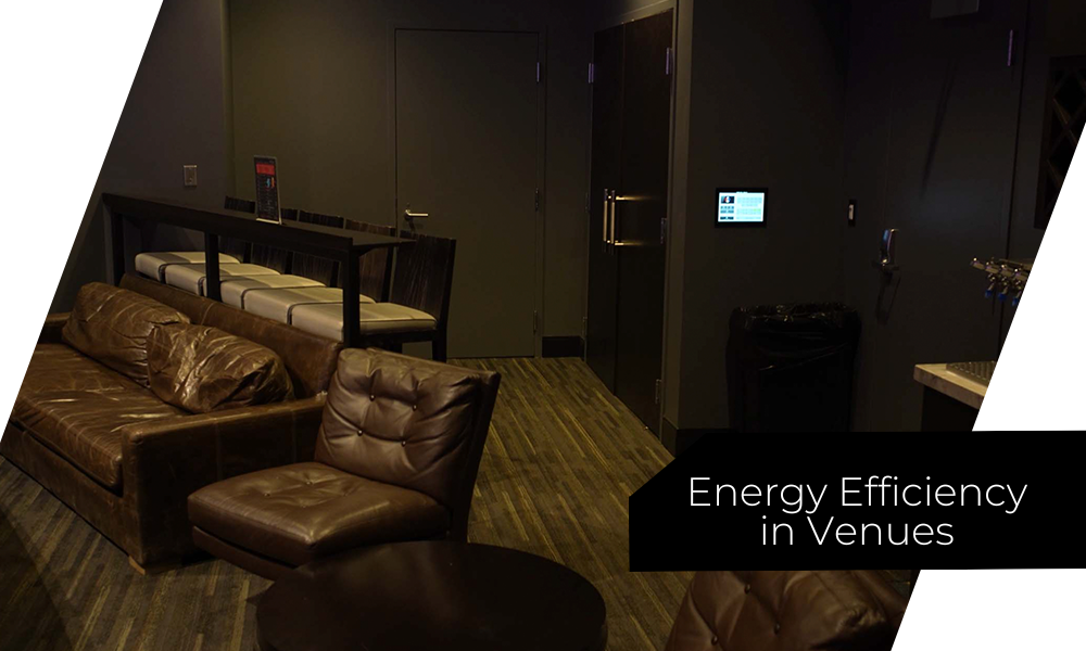Dim hotel lounge with brown leather sofas and low lighting.
